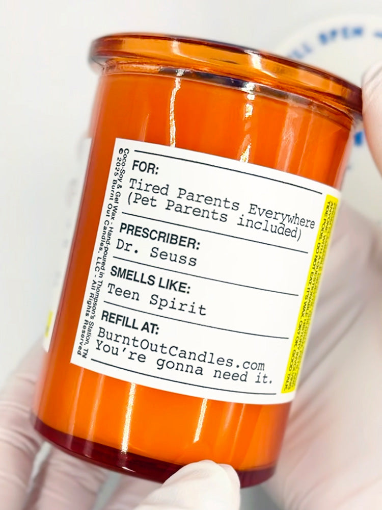 Orange candle jar with a humorous label 